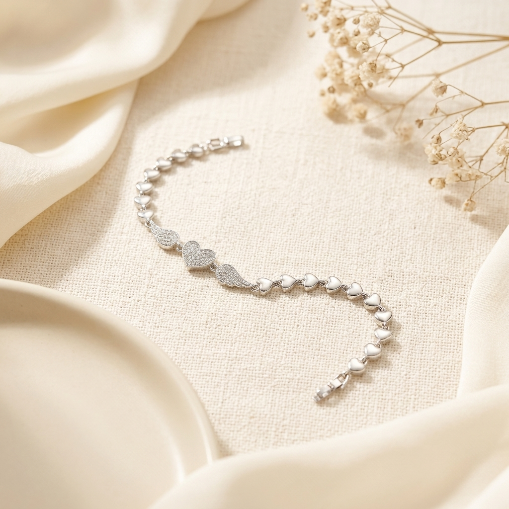 Silver Pave Angel Wing Heart Bracelet centrepiece close up on cream satin