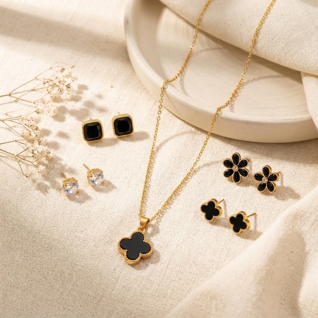 Black Clover Gold Necklace held in hand with baby's breath in background