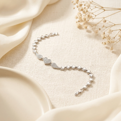 Silver Pave Angel Wing Heart Bracelet centrepiece close up on cream satin