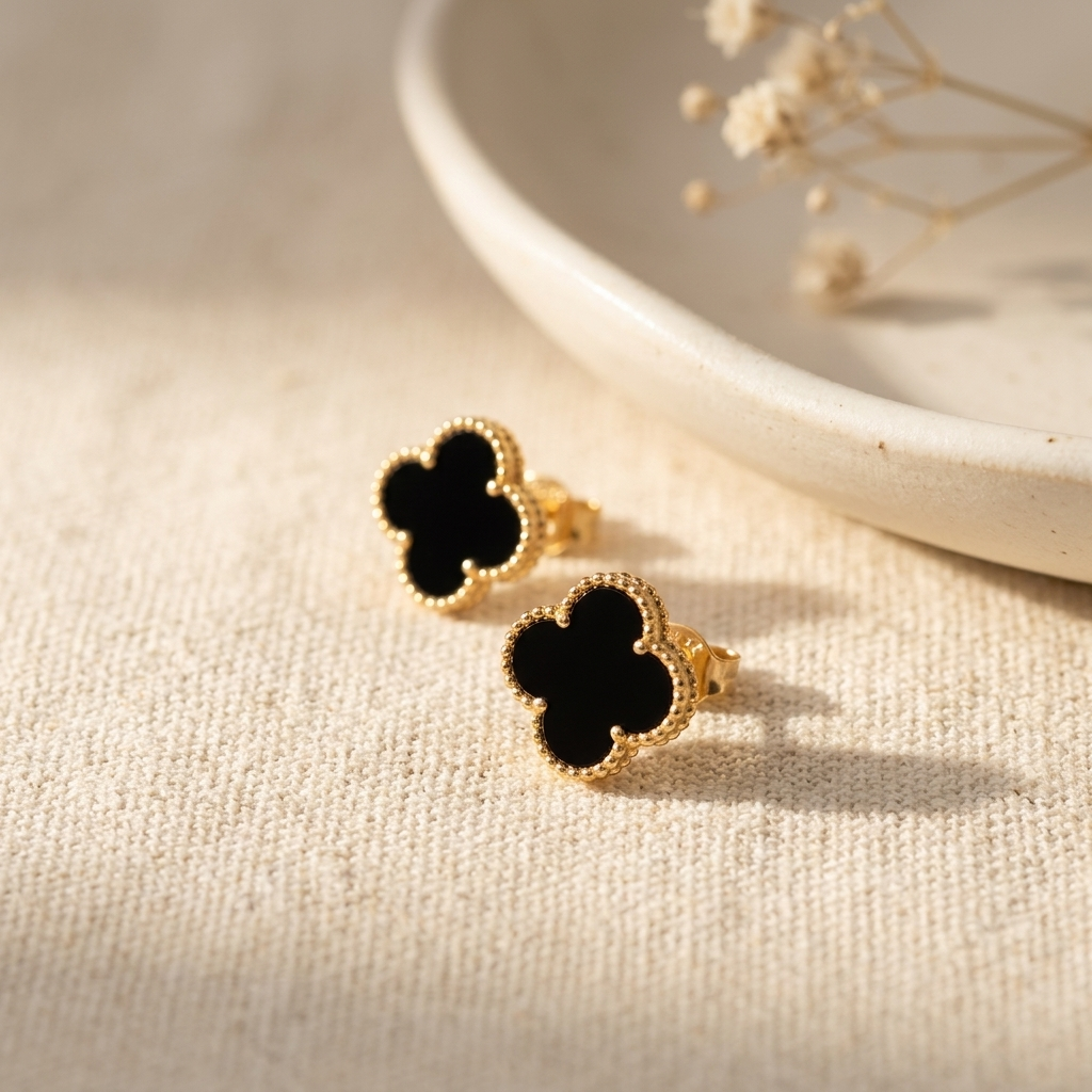 Black Clover Gold Jewellery Set lifestyle flat lay with dried botanicals