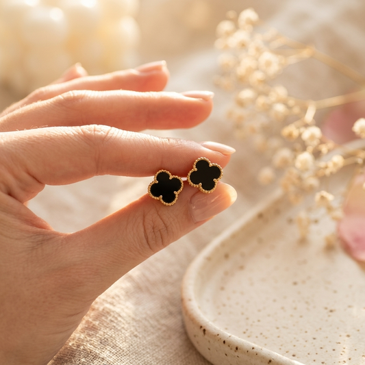 Black Clover Gold Jewellery Set flat lay showing necklace and all earring styles on cream linen