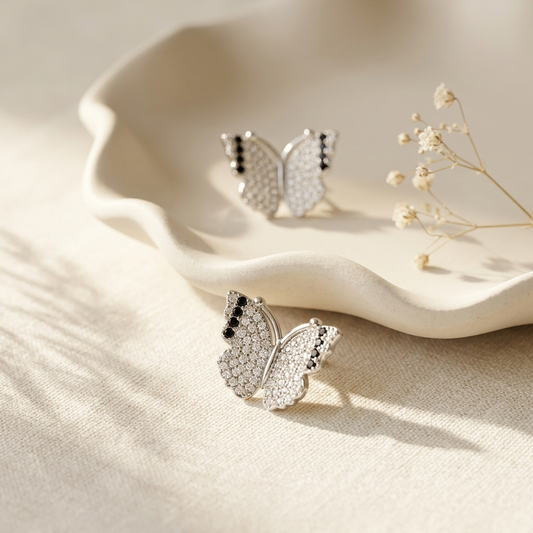 Silver Pave Butterfly Stud Earrings on linen with dried botanicals