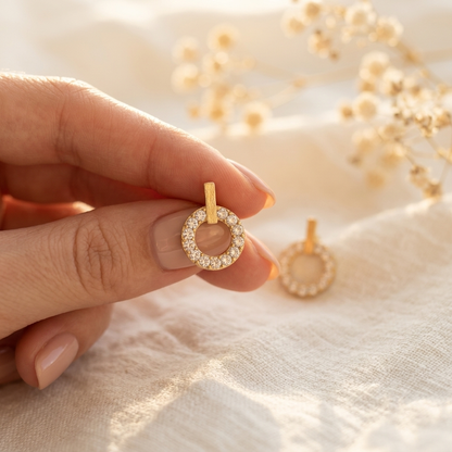 7-Day Gold Crystal Earrings Set – Starburst Pave Stud in gold held in hand