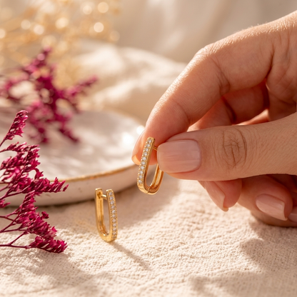 Gold Pave Rectangle Hoop Earrings on white linen surface