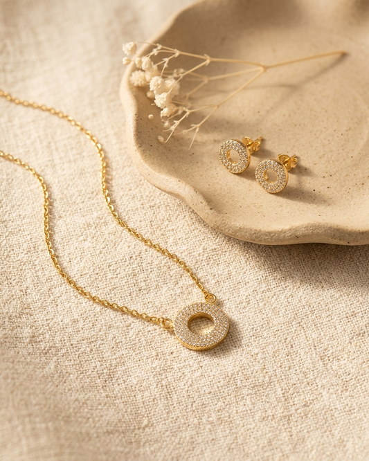 Gold Pave Circle Necklace and Earrings Set flat lay on plate