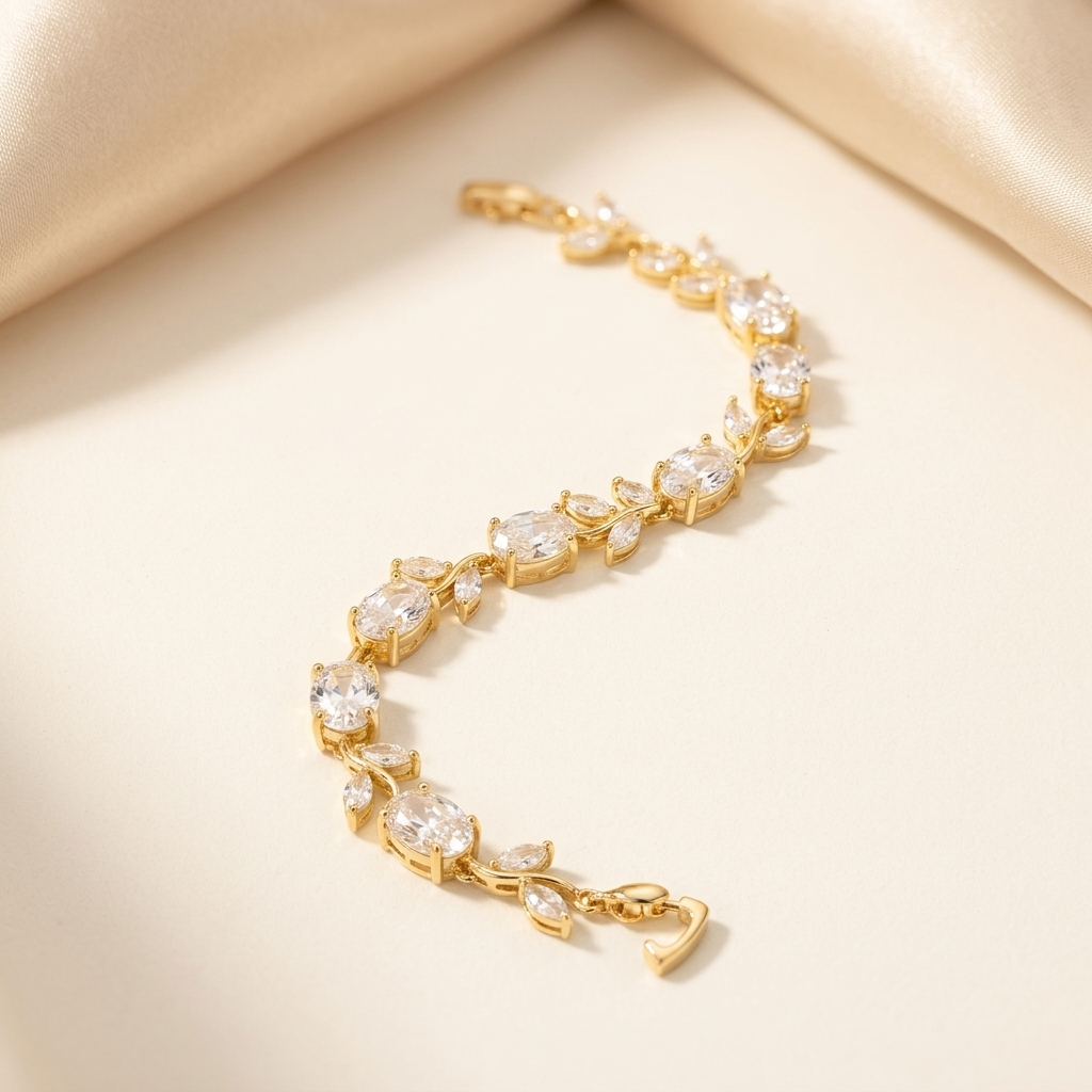 Gold White Stone Crystal Vine Leaf Bracelet laid flat on cream satin