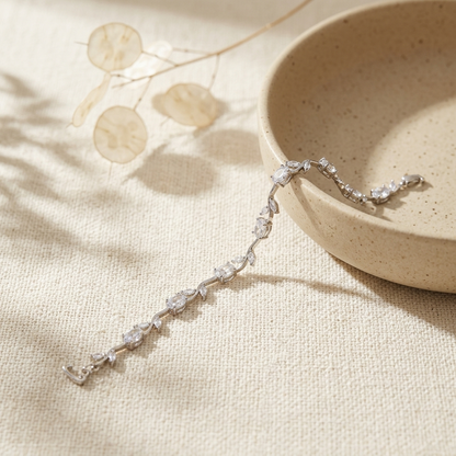 Silver White Stone Crystal Vine Leaf Bracelet draped on ceramic bowl with dried botanicals