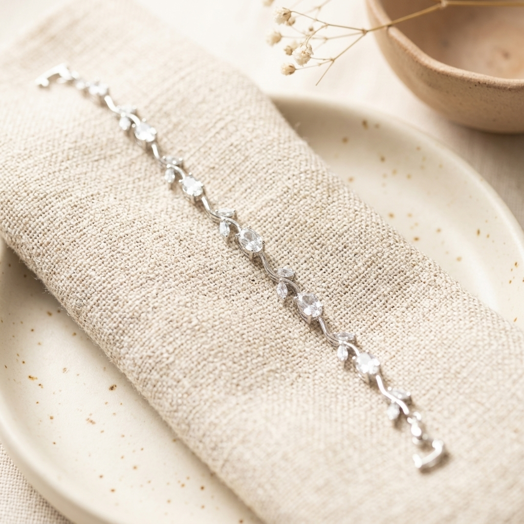 Silver White Stone Crystal Vine Leaf Bracelet on cream linen with ceramic plate