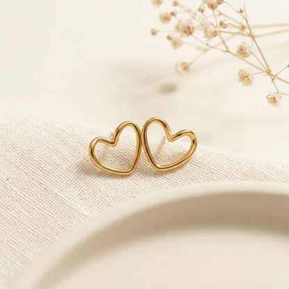 Gold Open Heart Stud Earrings held in hand close up