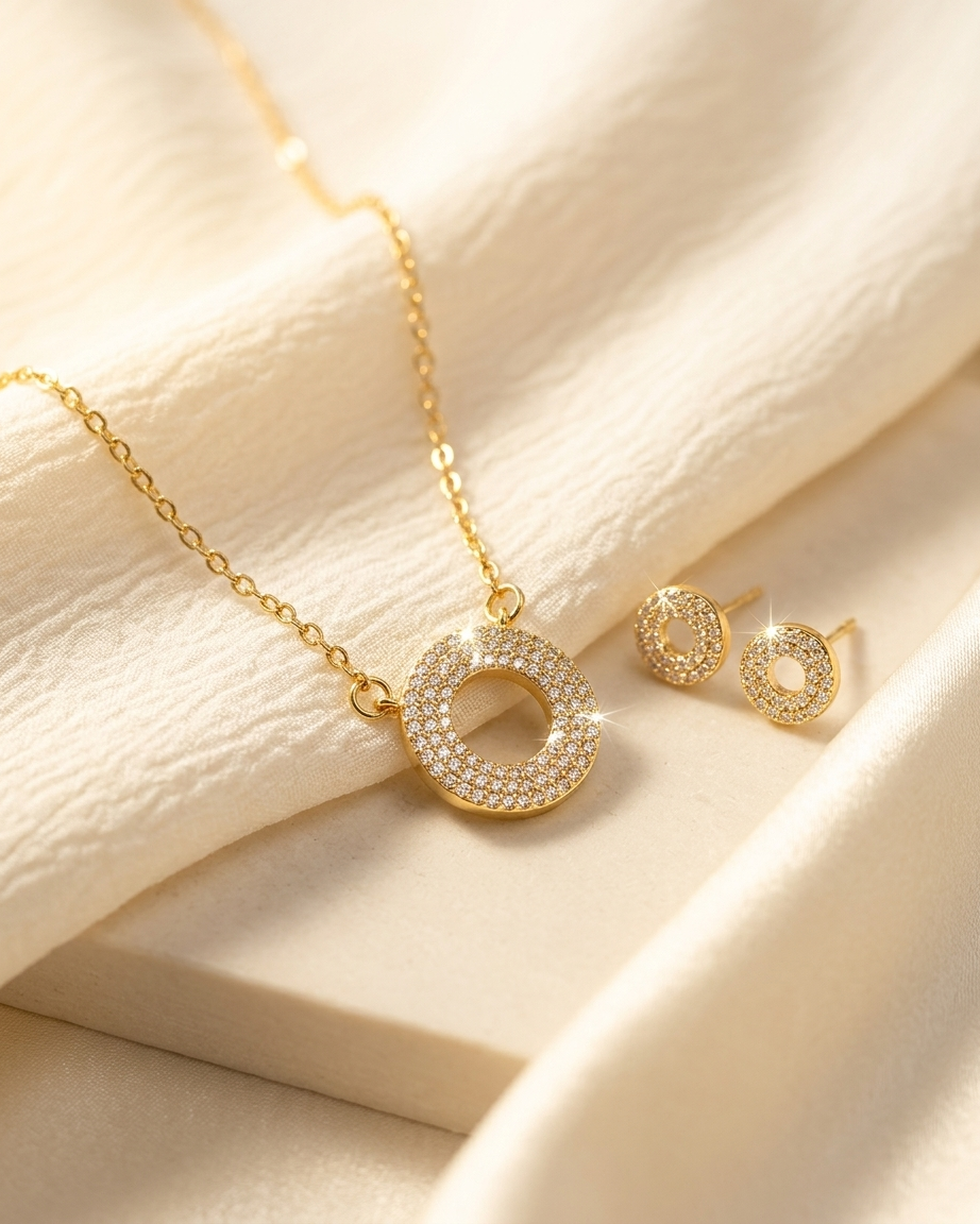 Gold Pave Circle Necklace and Earrings Set close up on white surface