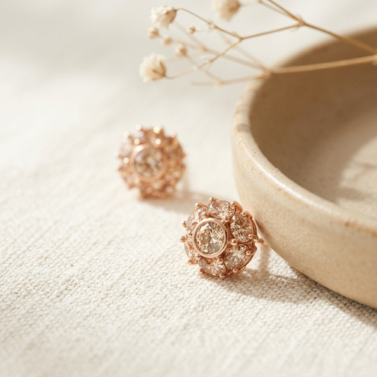 Rose Gold Crystal Flower Cluster Stud Earrings flat lay near ceramic bowl