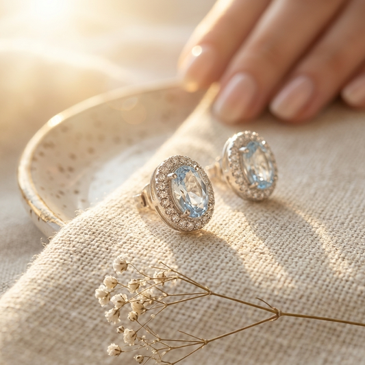 Silver Oval Halo Crystal Stud Earrings on linen with dried flowers and hand
