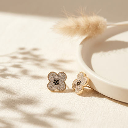 Gold Pave Four-Petal Flower Stud Earrings on ceramic tray with dried botanicals