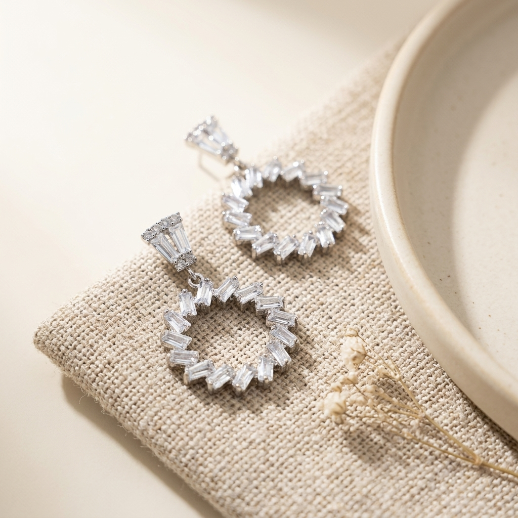 Silver Baguette Crystal Circle Drop Earrings on linen with ceramic bowl
